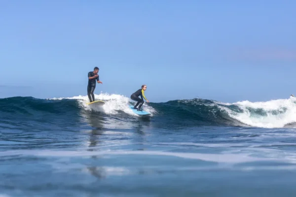 Surfers practicing their skills during a surf lesson in the waters of Tenerife.