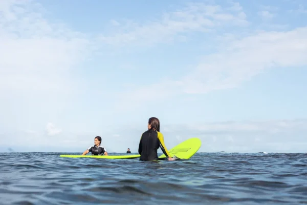 Softboards lined up on the beach at Rocky Point Surf School, Tenerife