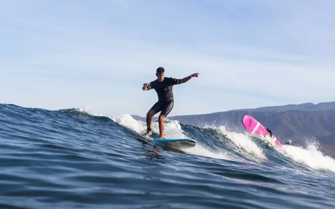 Surf instructor surfing early morning wave in Las Americas, Tenerife