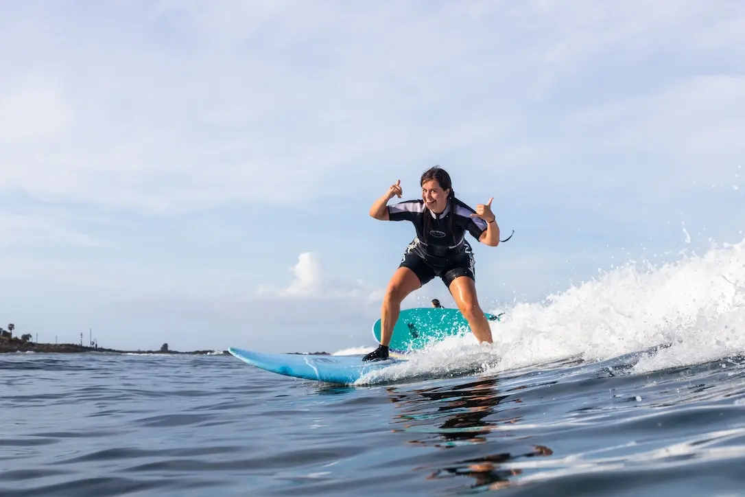 student riding a waves on a surf lesson in Tenerife